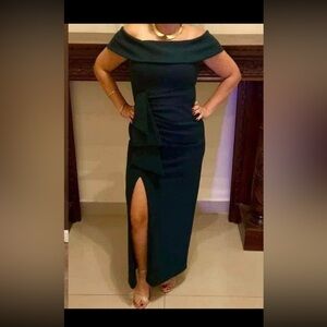 Green dress of the shoulders with slit on right side.